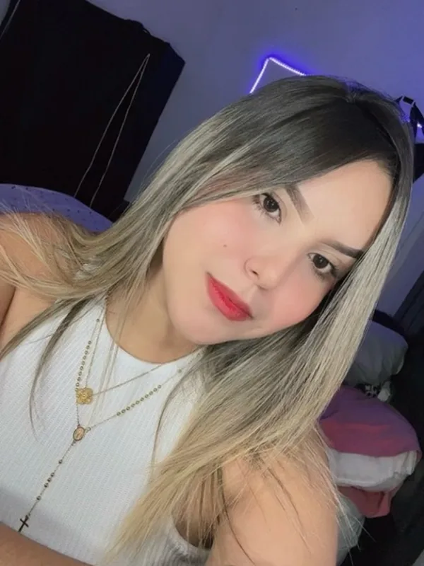 Blonde woman smiling at her phone camera